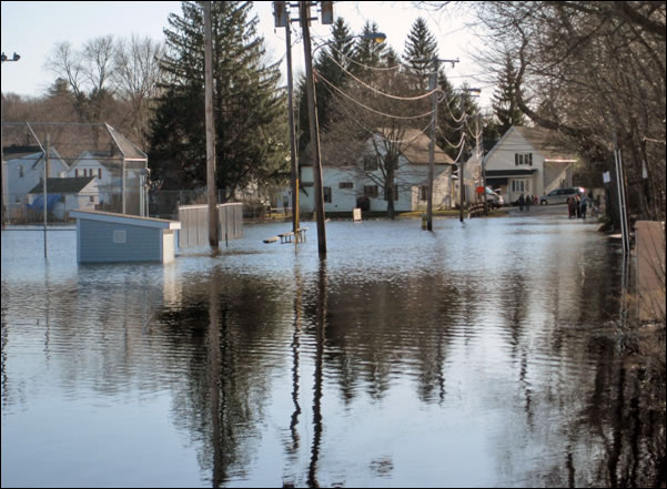 A flooded roadway in the Chicago area on a cloudy day.